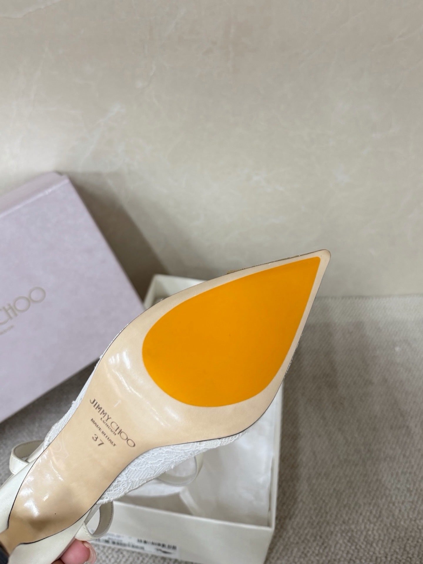 Jimmy Choo lace floral appliqué pumps.