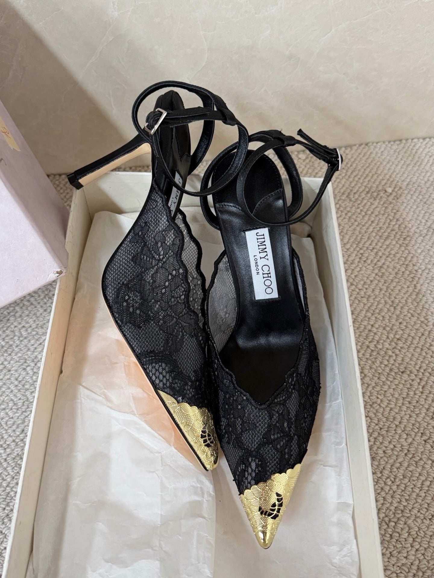 Jimmy Choo lace floral appliqué pumps.