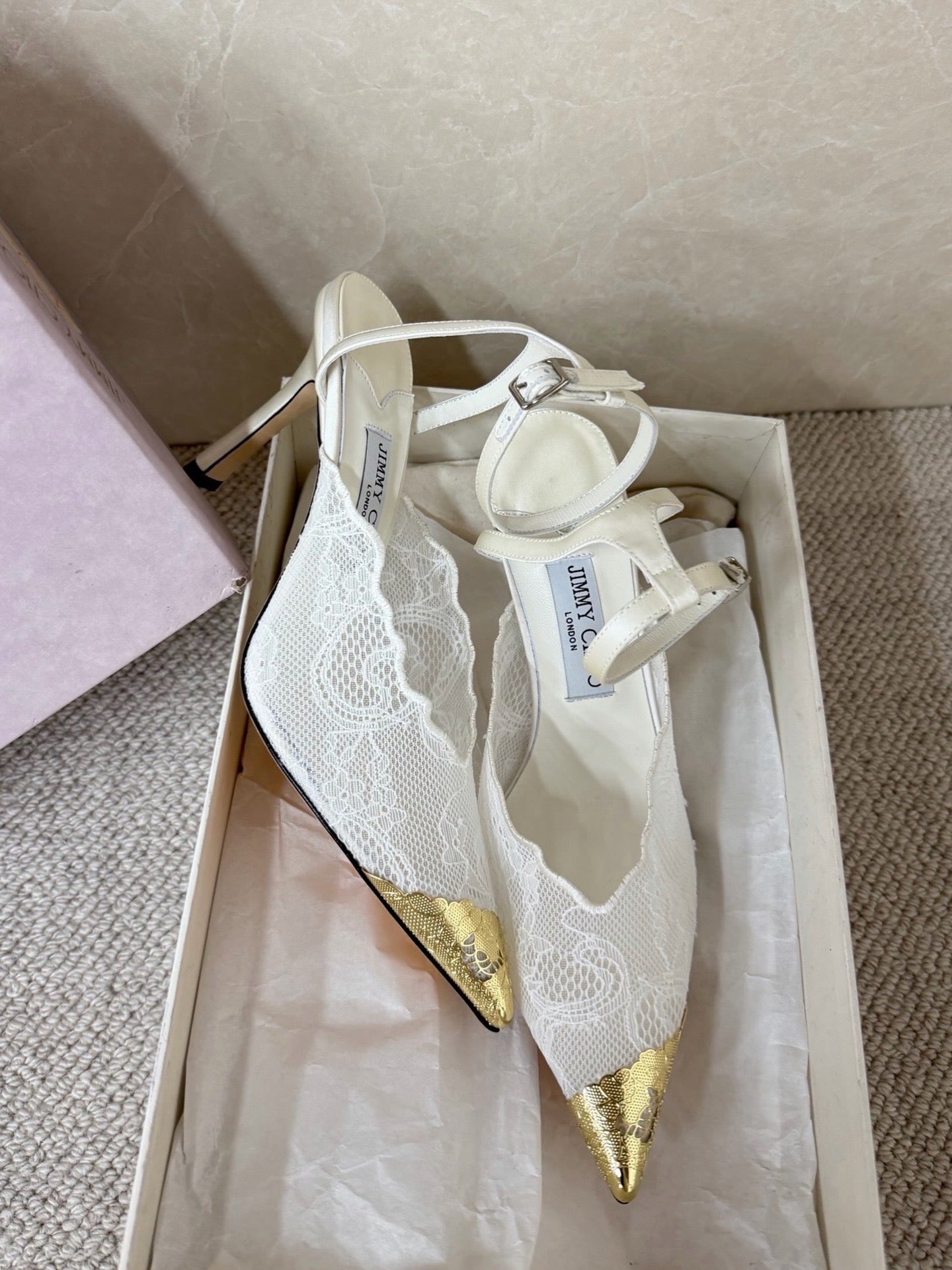 Jimmy Choo lace floral appliqué pumps.