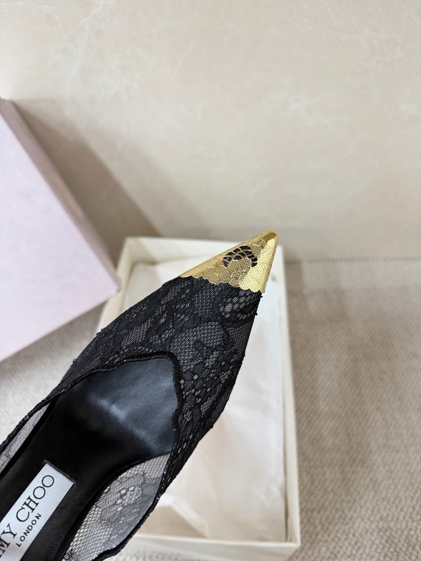 Jimmy Choo lace floral appliqué pumps.